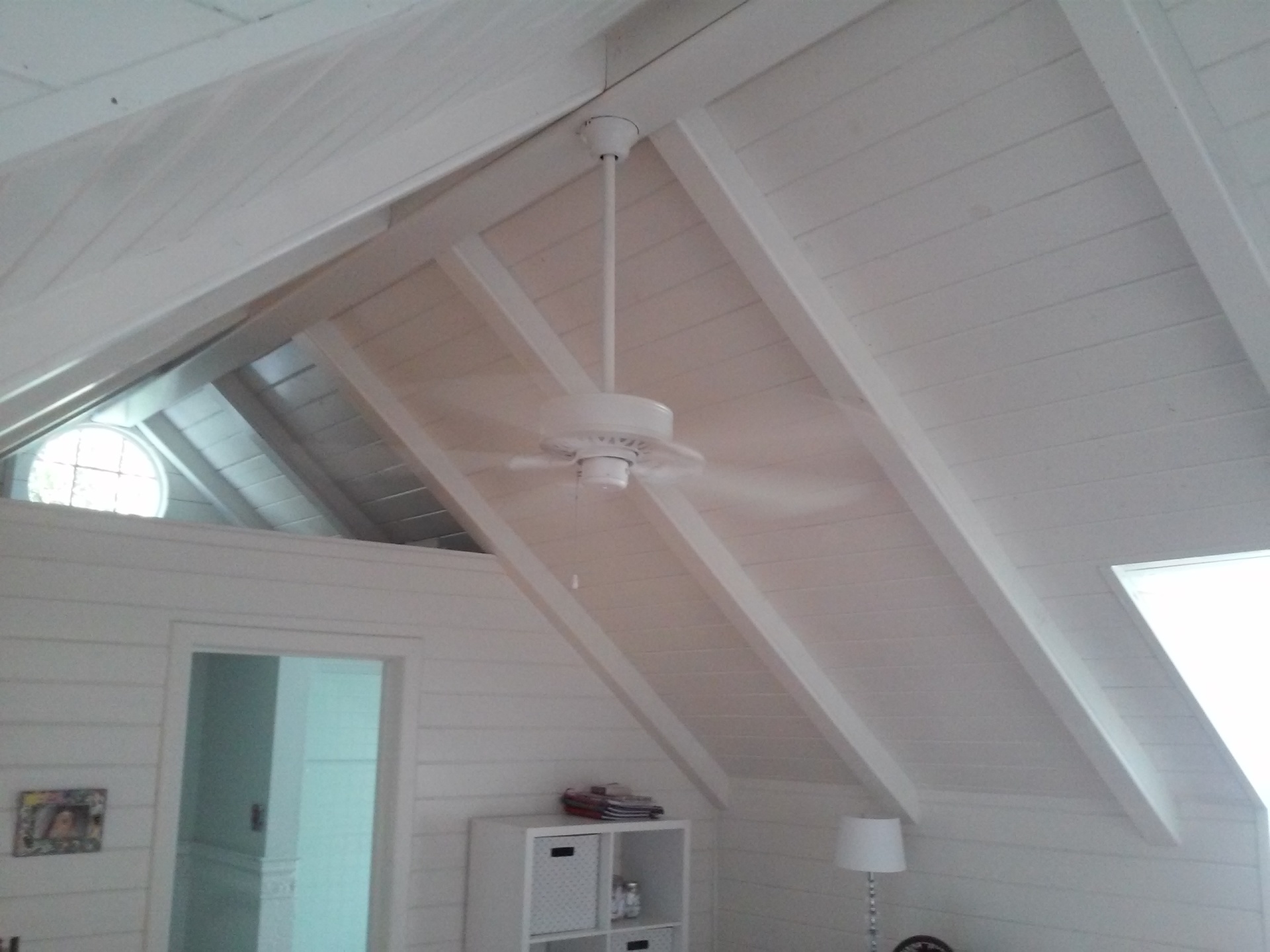 Atlanta Pro Repairs — white ceiling fan hung on a vaulted shiplap ceiling
