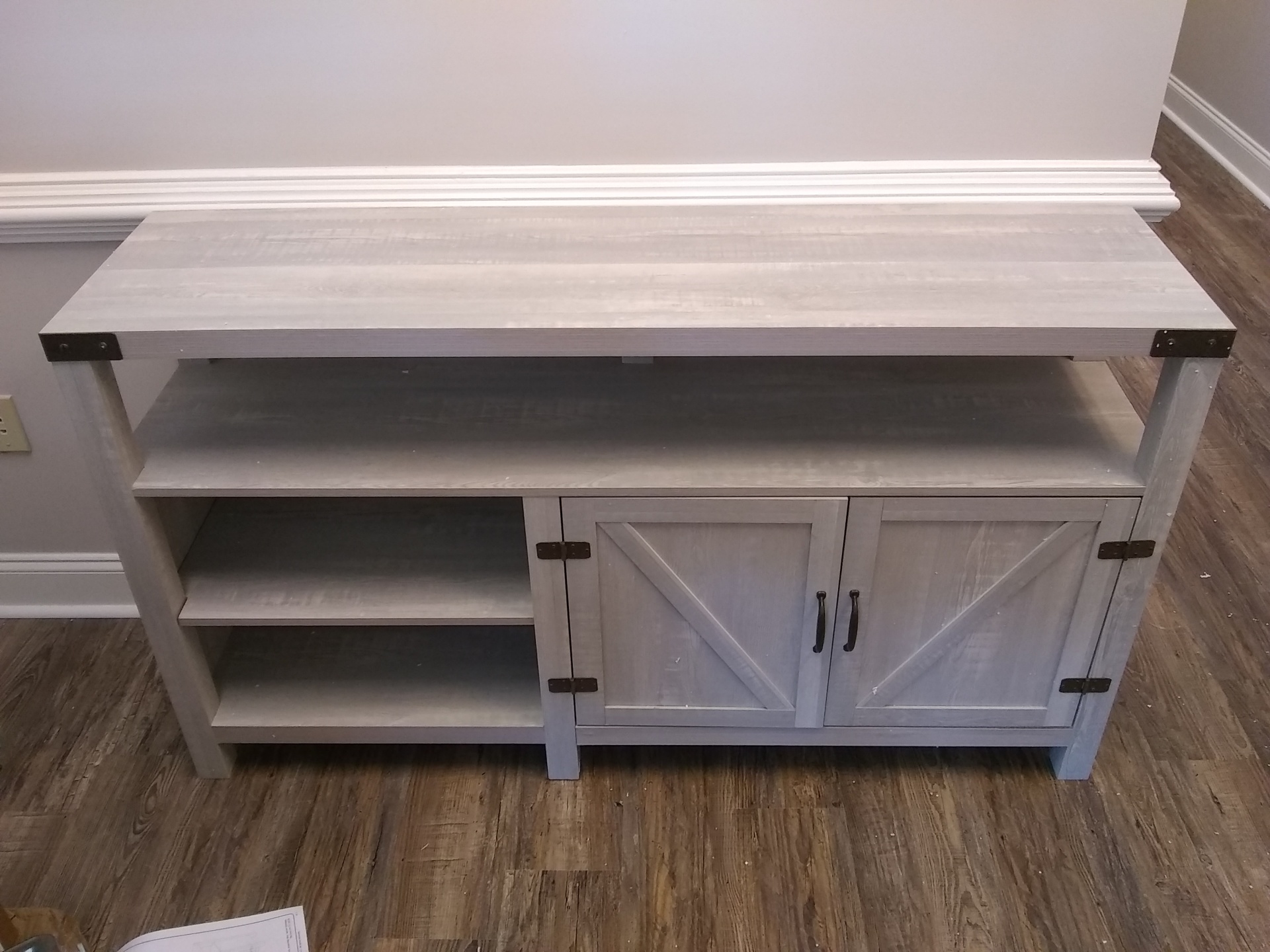Atlanta Pro Repairs — rustic farmhouse barn-door TV console assembled with iron hardware